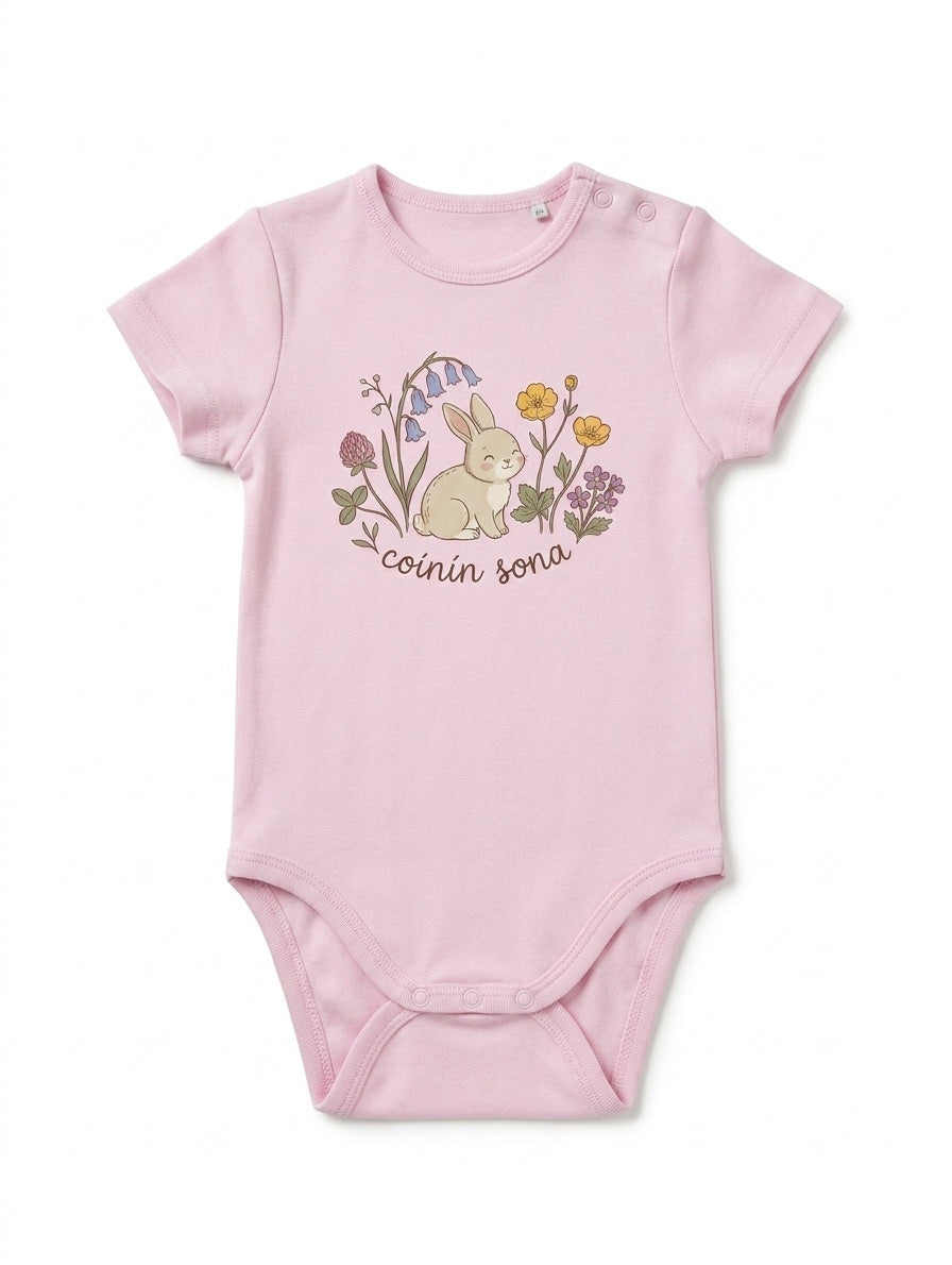 pink kids bodysuit with rabbit-floral illustration on white background