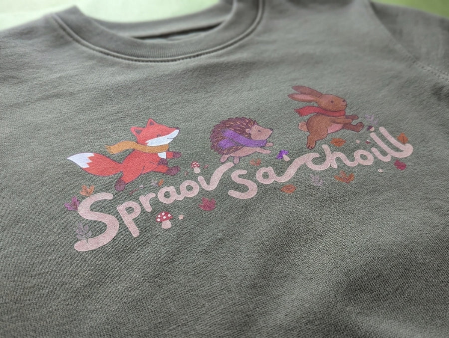 Close-up detail of spraoisachoill illustration on khaki sweatshirt