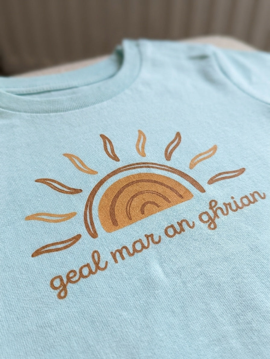 Close-up detail of sun illustration on blue t-shirt