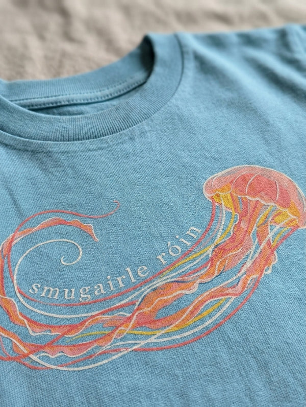 Close-up detail of jellyfish illustration on teal t-shirt