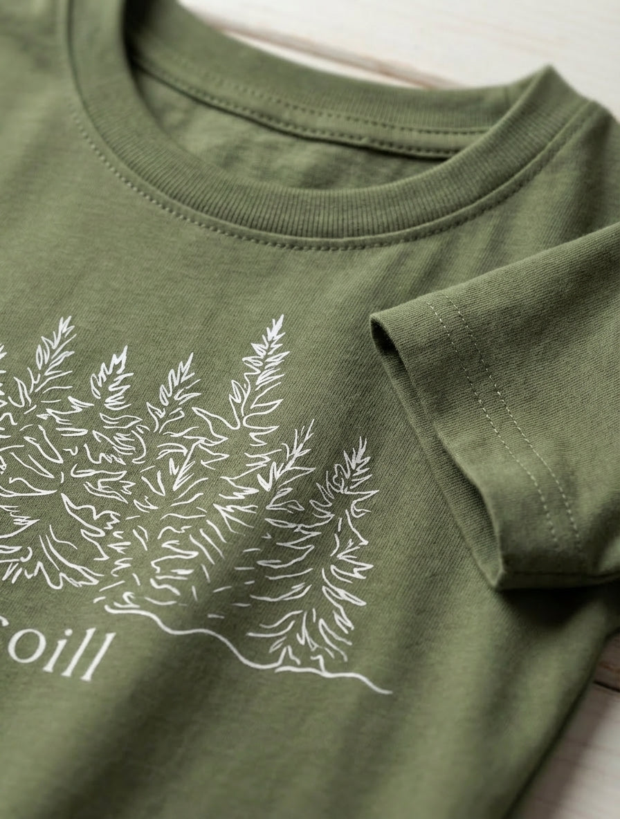 Close-up detail of trees illustration on green t-shirt