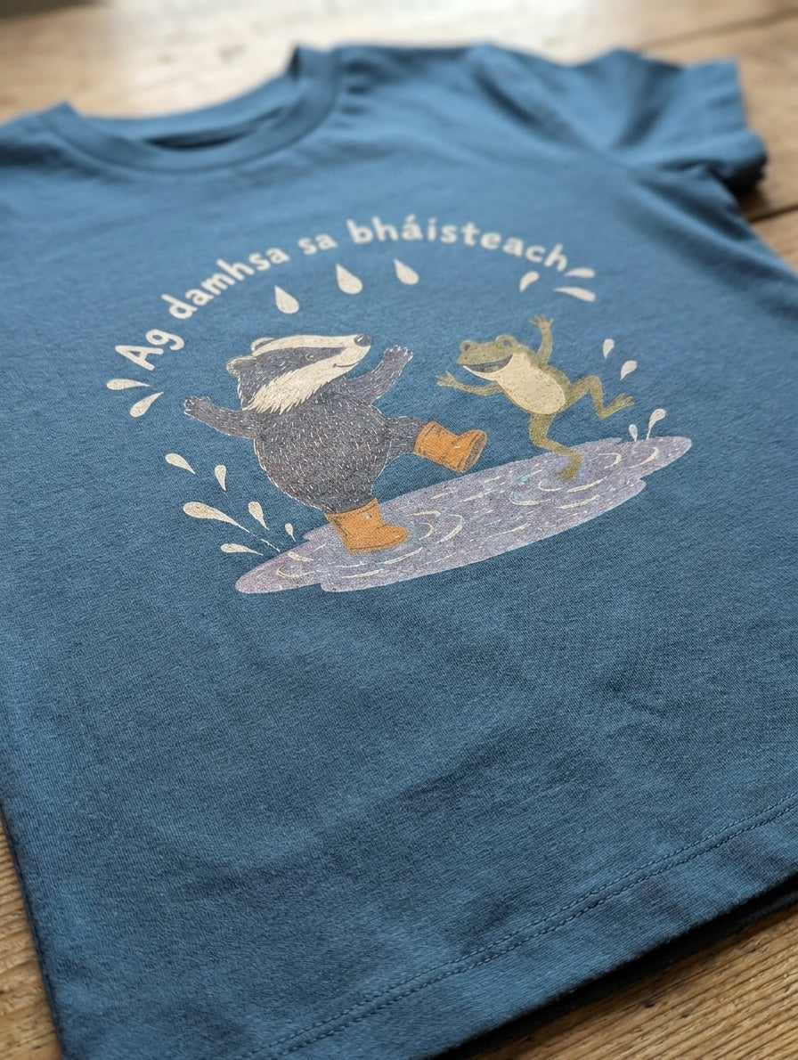 Close-up detail of badger-frog illustration on twilightblue t-shirt