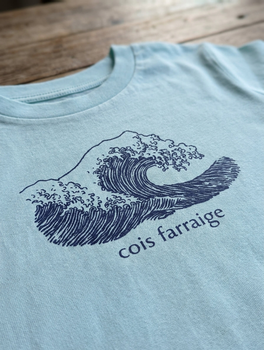 Close-up detail of wave illustration on poolblue t-shirt