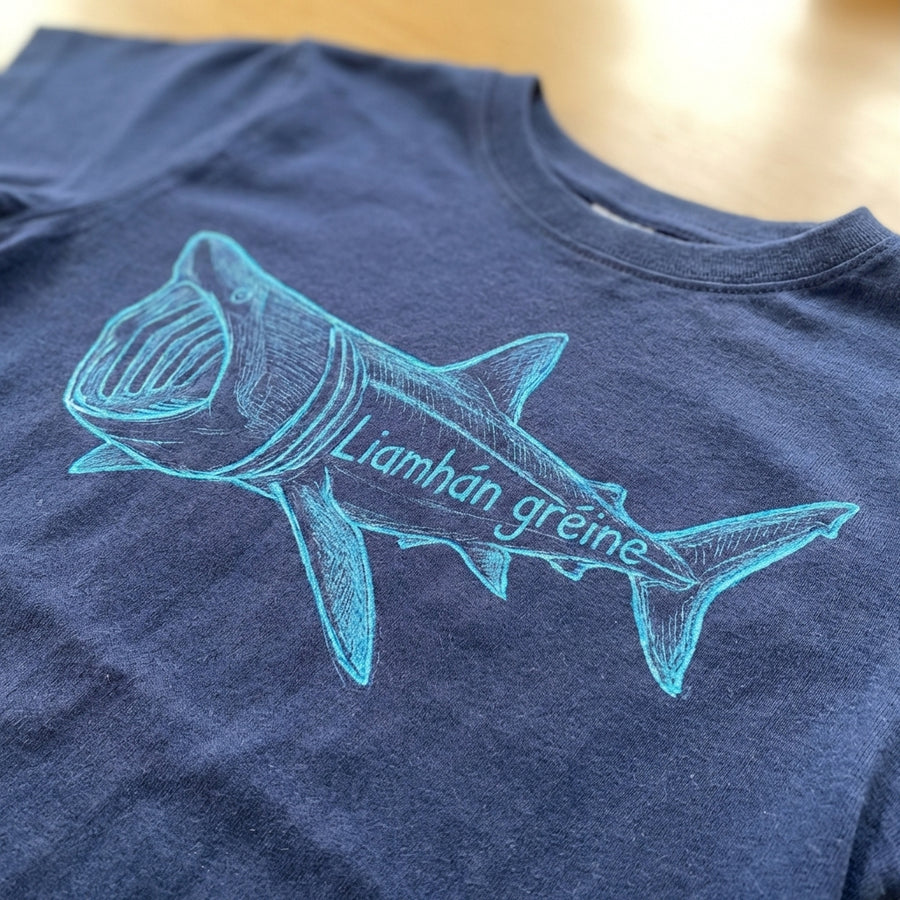 Close-up detail of shark illustration on blue t-shirt