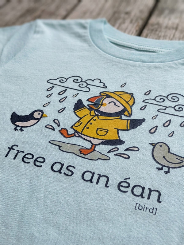 Close-up detail of puffin illustration on blue t-shirt