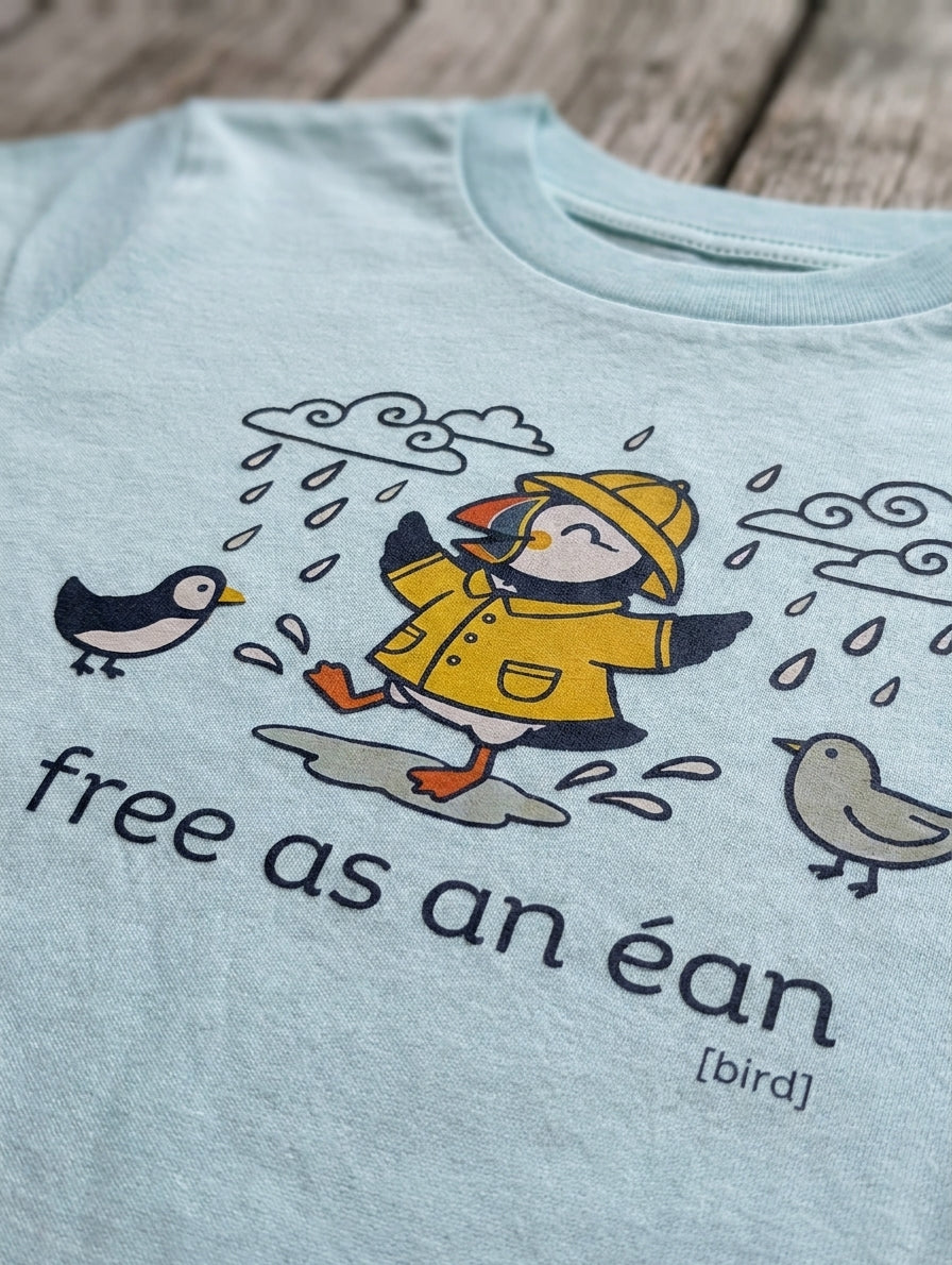 Close-up detail of puffin illustration on blue t-shirt