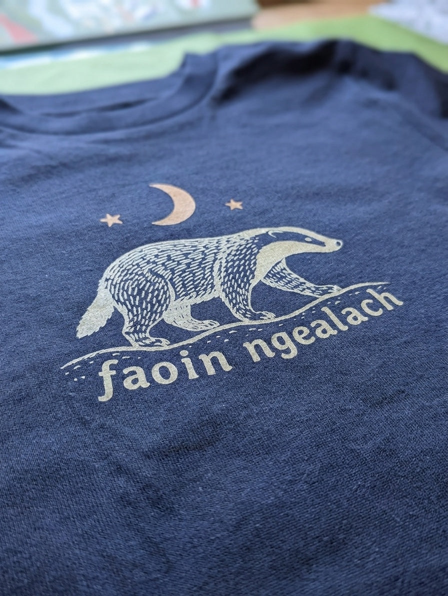 Close-up detail of faoin-ngealach illustration on navy t-shirt