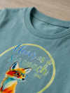 Close-up detail of fox illustration on teal t-shirt