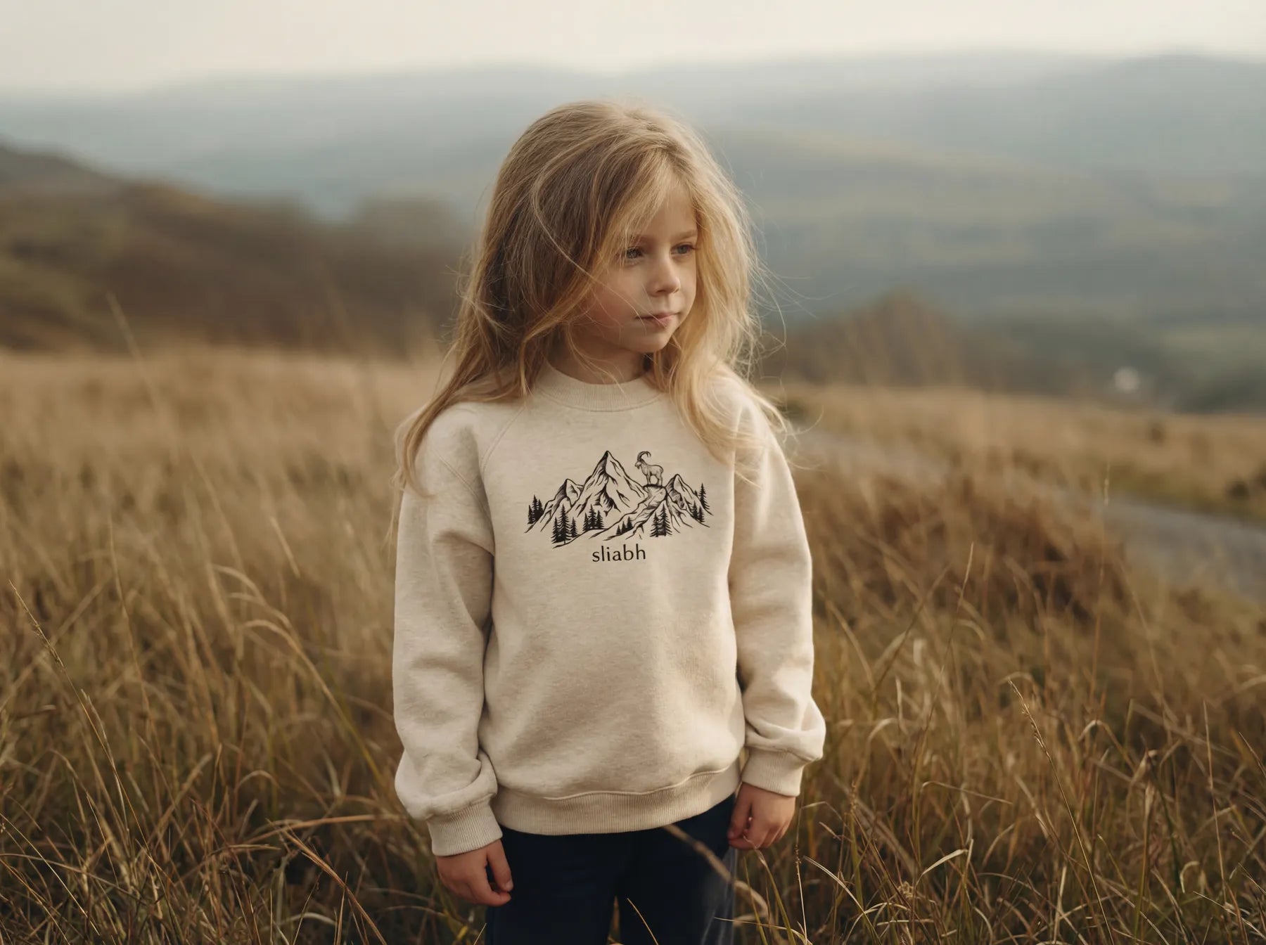 Child wearing Glasóg sliabh mountain sweatshirt outdoors in the Irish countryside